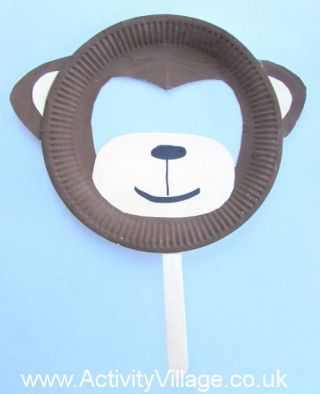 a paper plate shaped like a bear with a toothpick in it's mouth