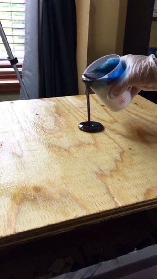 a person using a sanding machine on a wooden table