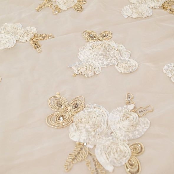 white and gold brooches on a table cloth