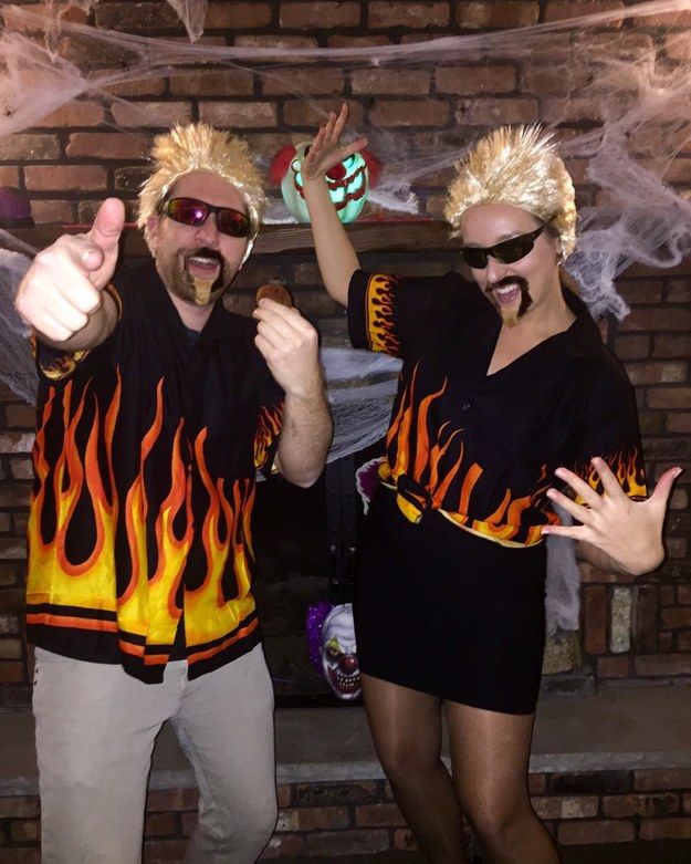 two people dressed in costumes standing next to each other with their hands up and thumbs up