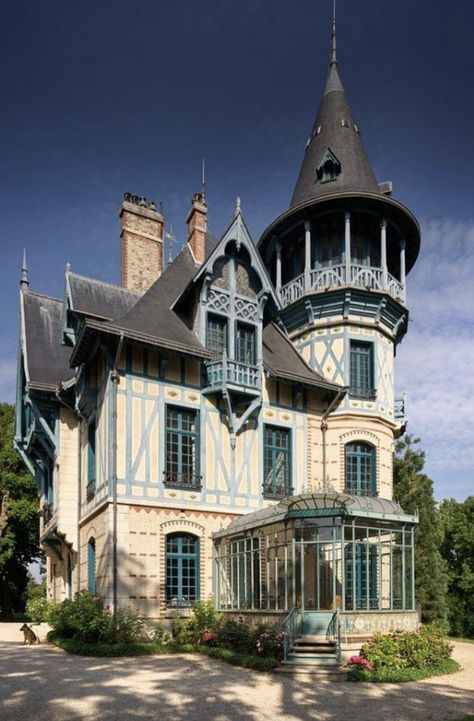 an old victorian style house with blue and white trim