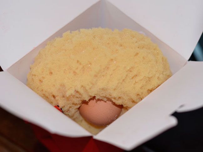 an egg in a box with some rice inside