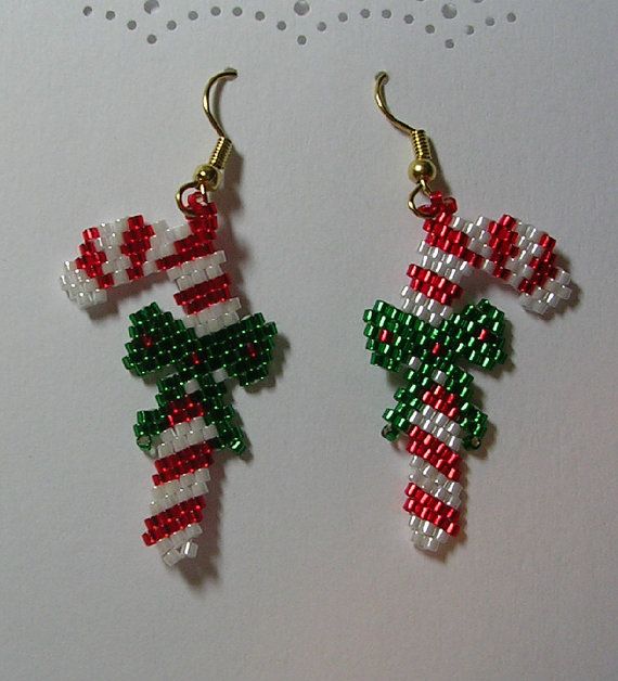 two christmas themed beaded earrings hanging from hooks