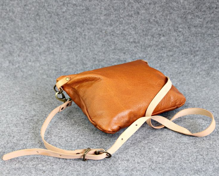 "Medium leather crossbody bag, Camel clutch purse, Leather every day purse, Every day bag, Brown- small leather cross body bag -Gift for women This small perfect size leather crossbody bag has two inner pockets, one which zips closed and one slip pocet for your phone. The satchel is made from soft italian distressed leather, lined with cotton lining for secure. It's designed it to be classy and minimal to match with any outfit. * Made from genuine Italian leather. * Adjustable crossbody strap. * Crossbody Clutch As A Gift, Everyday Shoulder Clutch With Leather Lining, Brown Crossbody Clutch As Gift, Crossbody Pouch With Adjustable Strap For Gift, Leather Crossbody Pouch, Flap Bag With Removable Pouch, Belt Bag With Adjustable Strap As Gift, Leather Shoulder Bag Clutch As Gift, Leather Pouch With Detachable Strap As Gift