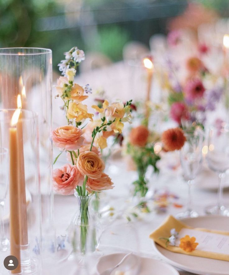 an image of a table setting with flowers and candles