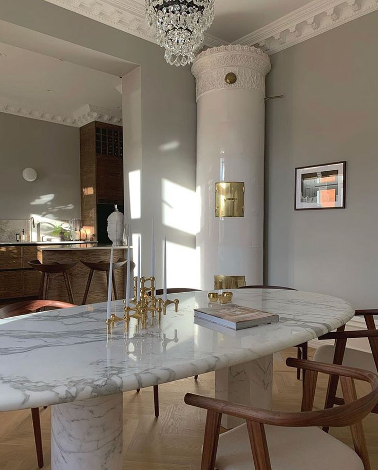 a marble dining table with chairs around it