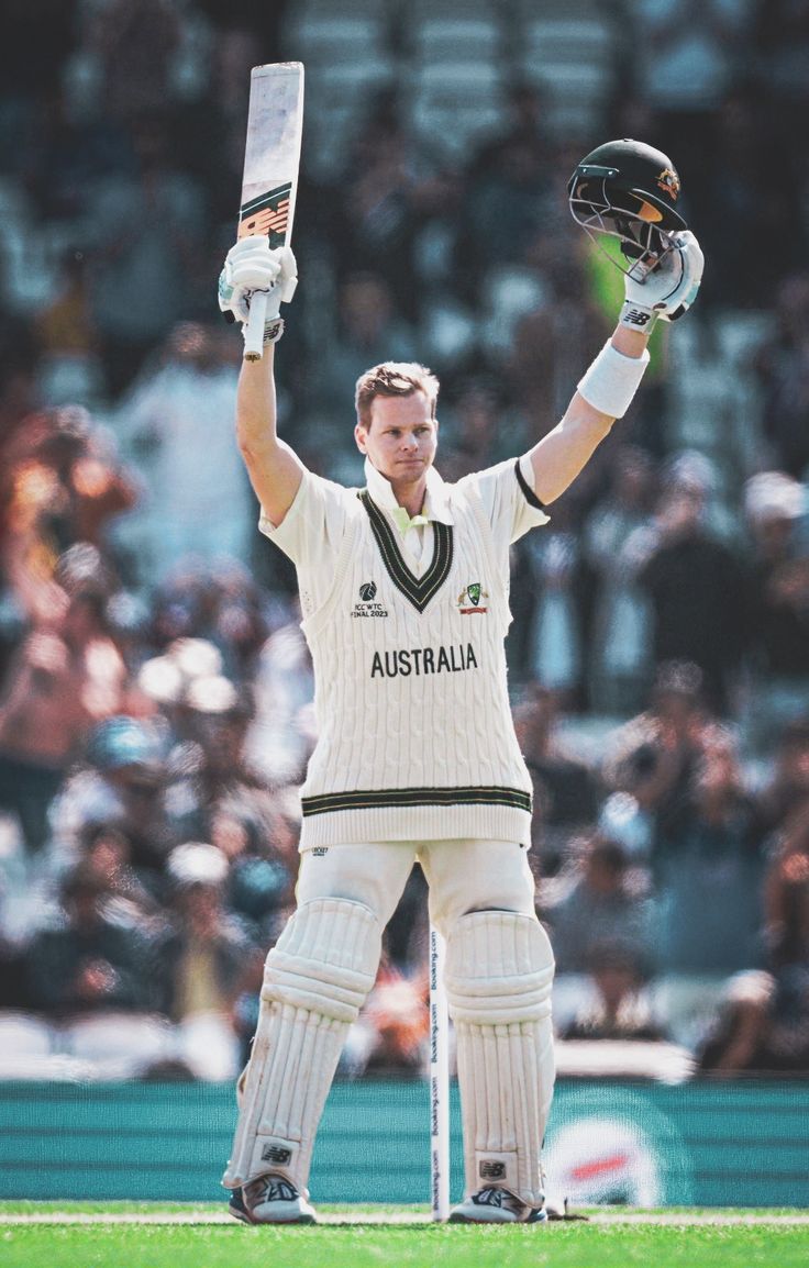 a cricket player holding his bat up in the air