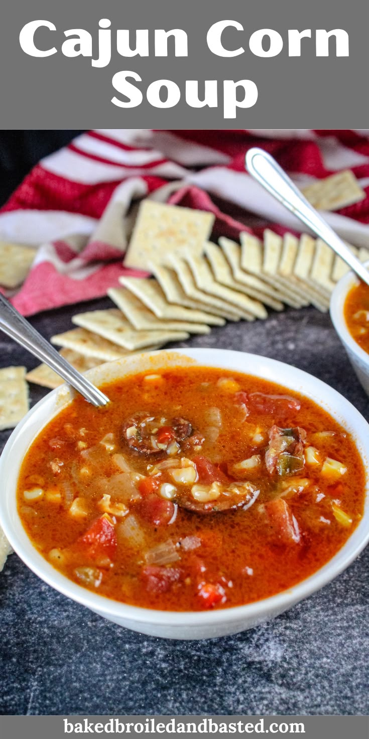 two bowls of cajun corn soup with crackers on the side