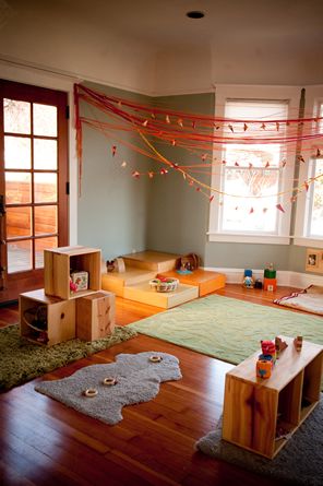 a living room filled with lots of furniture and decor on top of hard wood floors