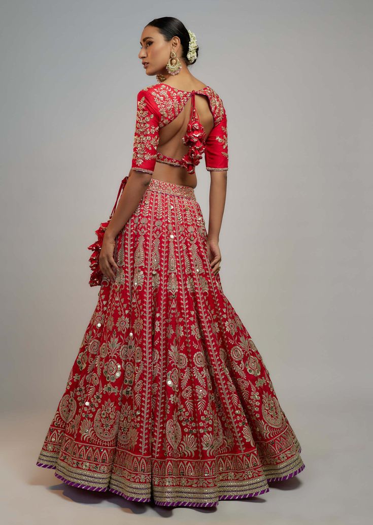 Editor's Note This exquisite lehenga set is a true embodiment of elegance and craftsmanship. Adorned with intricate hand and gold threadwork, skillfully crafted by artisans. Perfect for the bride's special day Festive Raw Silk Lehenga With Cutdana, Festive Raw Silk Lehenga With Cutdana Details, Wedding Raw Silk Sharara With Zari Work, Intricately Embroidered Raw Silk Sharara For Wedding, Intricate Embroidered Raw Silk Sharara For Wedding, Intricate Embroidery Anarkali Set For Wedding And Festivals, Resham Embroidered Raw Silk Choli For Wedding, Wedding Choli With Resham Embroidery In Raw Silk, Traditional Resham Embroidered Gown For Reception