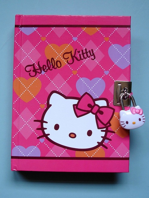 a hello kitty book with a keychain attached to it's front cover