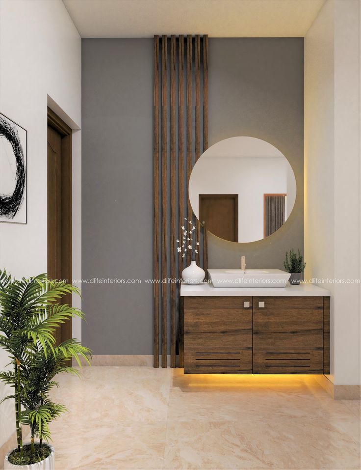 a bathroom with a mirror, sink and plant in the corner on the counter top