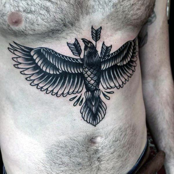 a man's chest with a bird tattoo on his stomach and an arrow in the middle