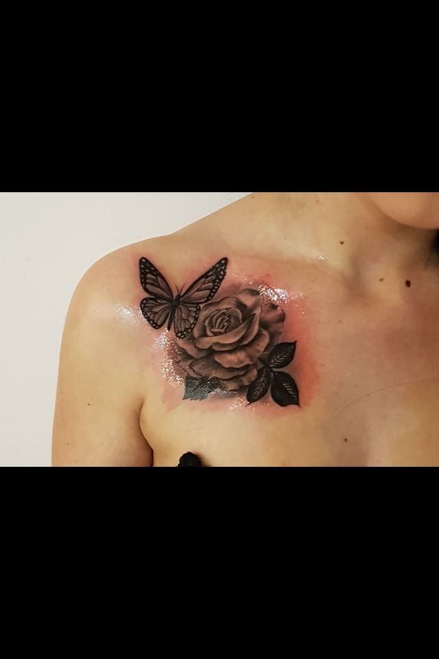 a woman with a butterfly and rose tattoo on her chest