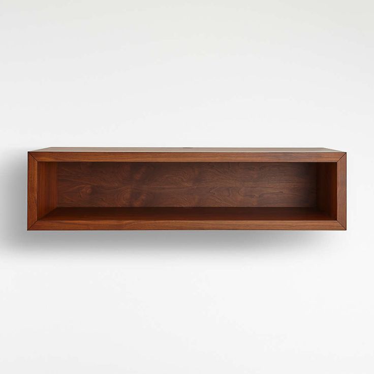 an empty wooden shelf on the wall with no one in it or someone out front