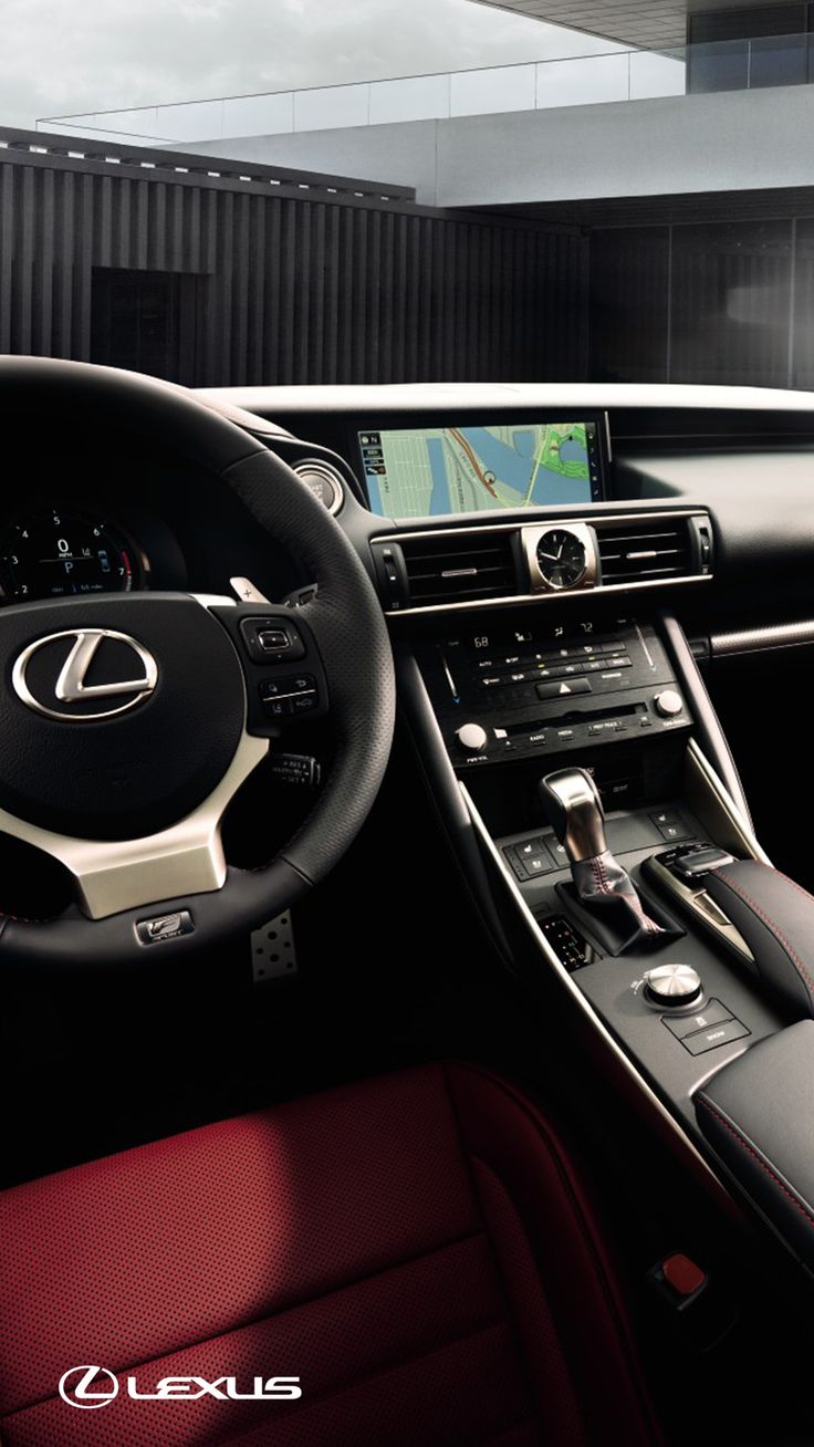 the interior of a car with red leather seats and steering wheel, including an electronic display