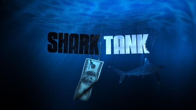 the words shark tank are hanging from a hook in the water, with a dollar bill underneath it