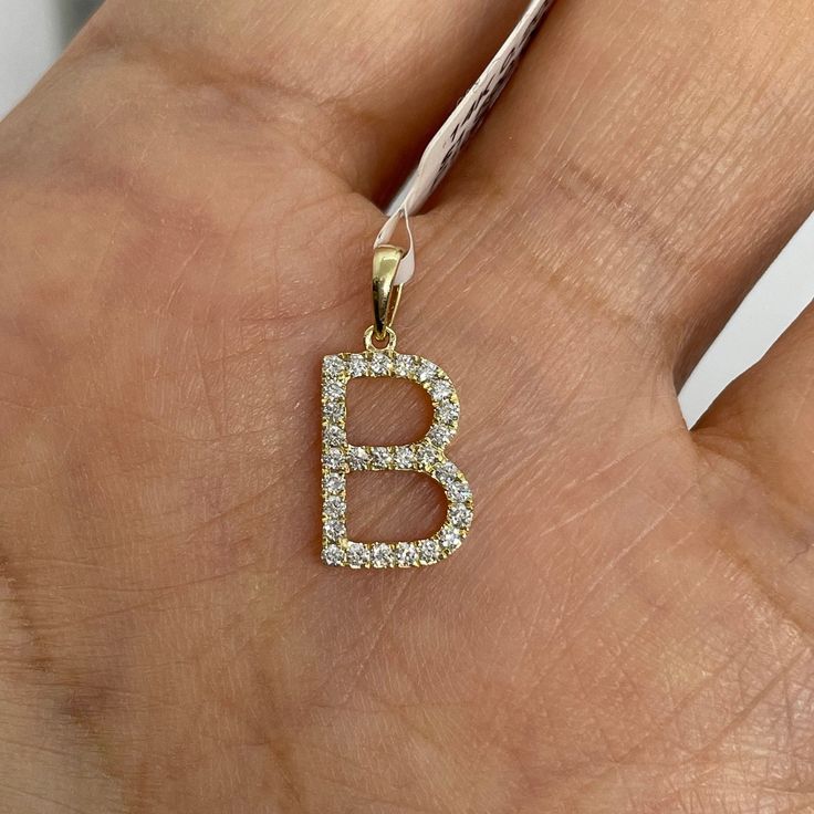 Dainty Letter B diamond initial pendant yellow gold.  Excellent craftsmanship, set with nice and sparkling diamonds.  Lays flat on.  Very simple and pretty pendant to wear on its own or layer with other necklaces.  Diamonds are set smooth, won't catch on things.  B measures from top of bail down about 17 x 8mm.   Natural Round Brilliant Cut Diamonds  Total Weight: 0.13 carats Clarity: SI/I Color: G 14K Yellow gold  Comes with gift box * We have been in the wholesale Jewelry business for over 30 years serving the community at the same location.  All diamonds we use are natural stones and fine quality gold.  Absolutely NO clarity enhanced or treated diamonds. Our jewelry pieces are handcrafted with fine craftsmanship and good quality stones. Our prices are wholesale prices.  We strive to bri B Initial, Initial B, Pendant Diamond, Pretty Pendant, Letter B, Initial Pendant, Initial Charm, Jewelry Business, Sparkle Diamonds