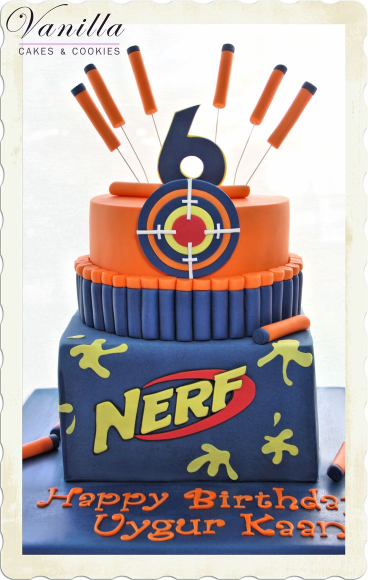 a birthday cake with an arrow and target design on the top that says nerf happy birthday yyggin kery