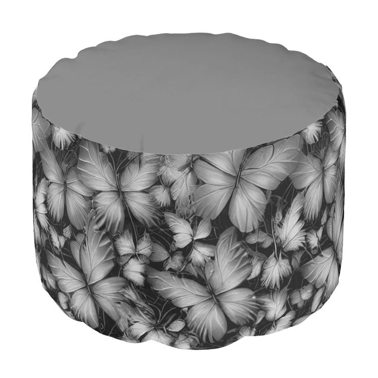 a black and white photo of butterflies on a round ottoman