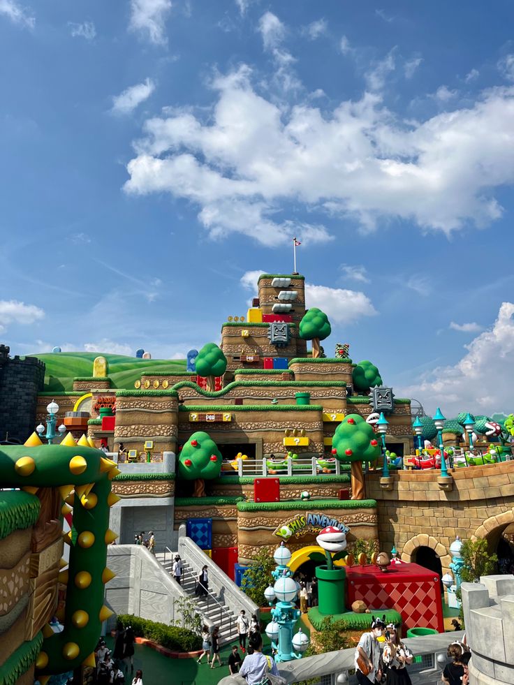 people are walking around in front of a building with lots of decorations on the roof