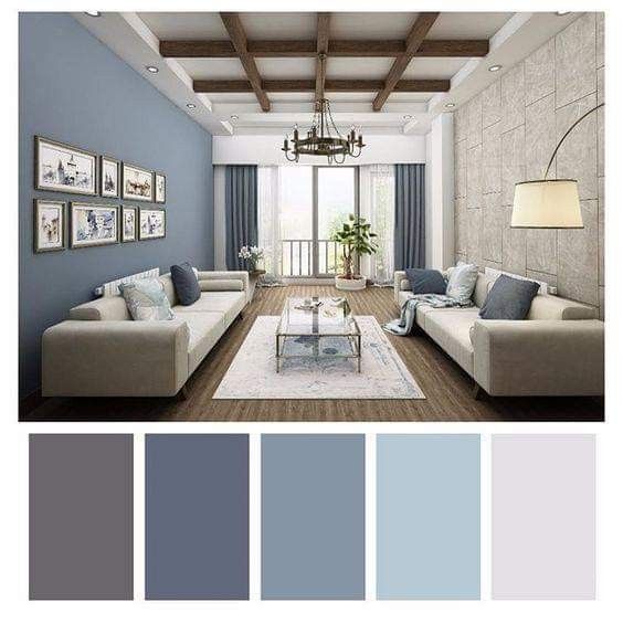 a living room with blue walls and white furniture