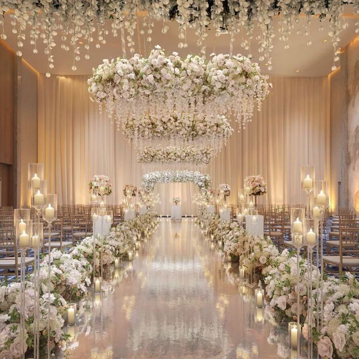 the aisle is decorated with white flowers and candles for an elegant wedding ceremony at the four seasons hotel