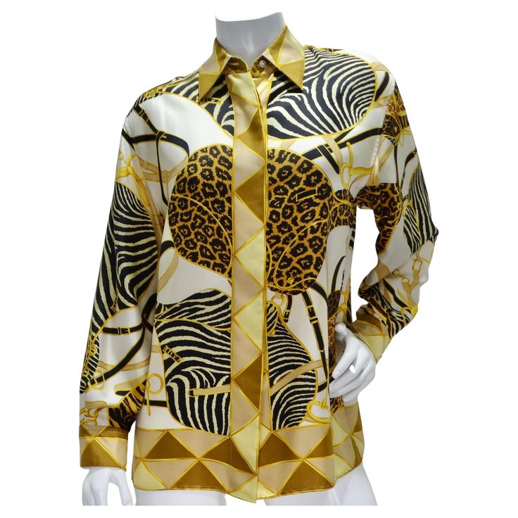 Elevate your wardrobe with the timeless sophistication of this Gucci 1990s Silk Printed Button-Up Shirt. Crafted from luxurious 100% silk, this classic collared shirt exudes luxury and refinement. The shirt features a captivating print in black, brown, white, and yellow, showcasing contrasting zebra and leopard panels intertwined with signature Gucci motifs. This bold yet elegant design adds a touch of glamour and individuality to any ensemble, making it a standout piece in your collection. Acce Luxury Gucci Women's Blouse, Luxury Fitted Gucci Shirt, Luxury Gucci Blouse For Office, Luxury Gucci Elegant Tops, Gucci Luxury Designer Shirt, Gucci Long Sleeve Top With Button Closure, Gucci Tops For Work With Button Closure, Elegant Gucci Top With Button Closure, Fitted Gucci Top With Button Closure