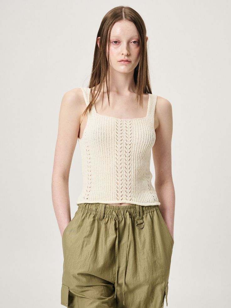 Editor's Notes Soft and stretchy, this slim fitting knit top features deep neckline and unique crochet and ribbed textured design. Wear yours alone, or layer with various items. - Cotton and nylon blend knit fabric- Fitted design for feminine mood- Rolled hem detail- Casual and natural feelMeasurements(in.)Size One Size(XS-M)- Shoulder: 7.48 in - Bust: 12.01 in - Length: 17.52 in * Model info: Height 5' 9 Bust 29 Waist 23 Hips 35 / Height 5' 8 Bust 31 Waist 23 Hips 35Composition & Care- 65% Cotton, 35% Nylon - Dry Cleaning only Designer- by ETMON Seamless Knit Sweater Vest For Spring, Fitted Beige Knit Tank Top, Spring Seamless Knit Sweater Vest, Chic Fitted Camisole Crochet Top, Chic Fitted Crochet Camisole Top, Spring Knit Sweater Vest Seamless, Fitted Chic Crochet Camisole Top, Chic Fitted Crochet Tank Top, Beige Knitted Tank Top