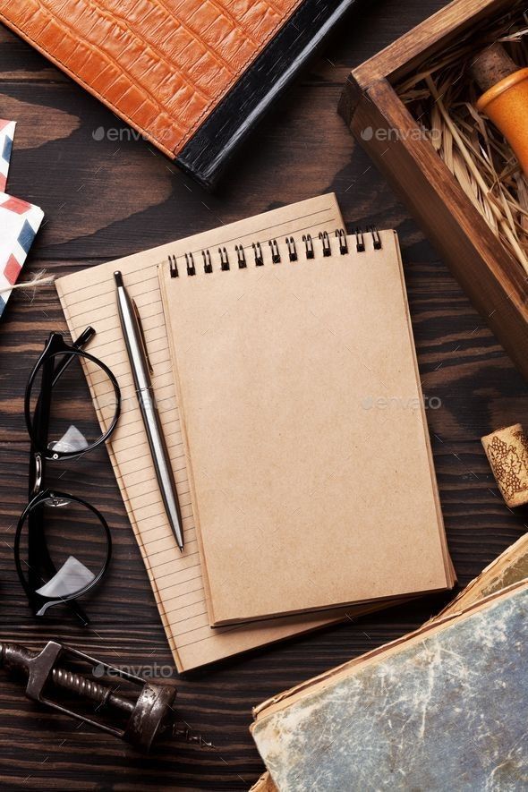 an open notebook, pen and other items on a wooden table - stock photo - images