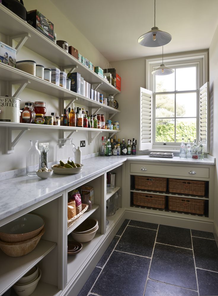 a kitchen filled with lots of counter top space next to a stove top oven under a window