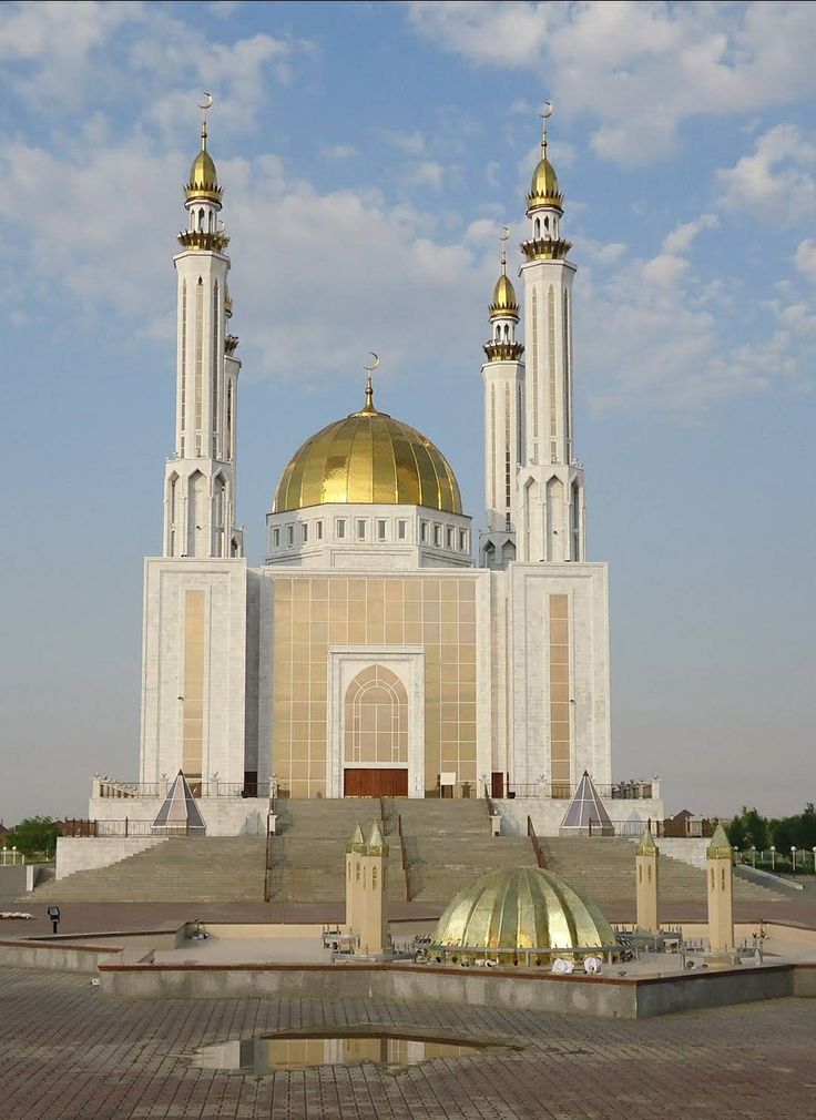 a large white building with two golden domes