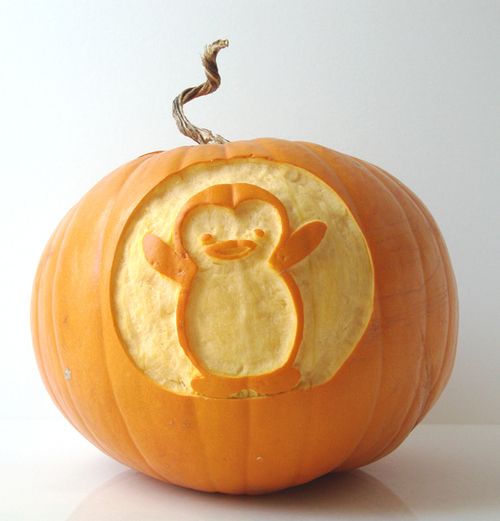 a carved pumpkin with an image of a penguin on it