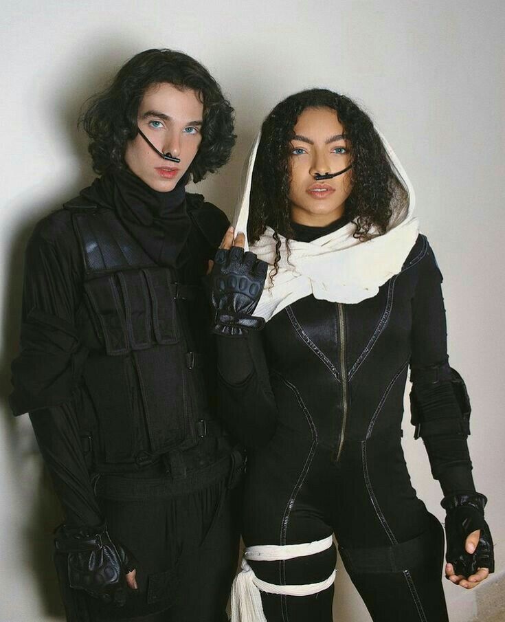 two people dressed in black and white posing for the camera