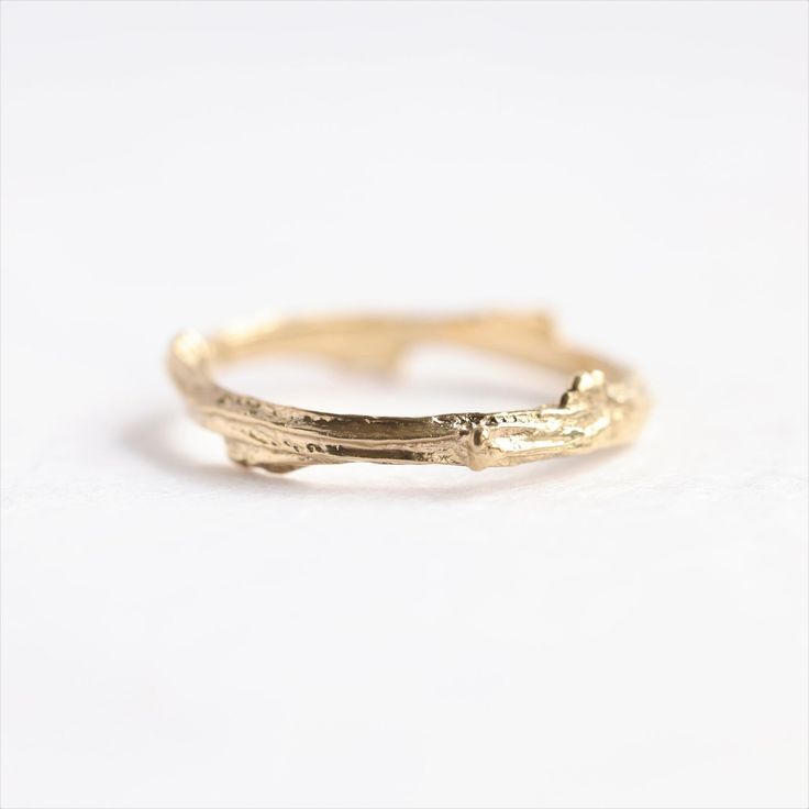 a gold ring that has been made to look like it is in the shape of a branch