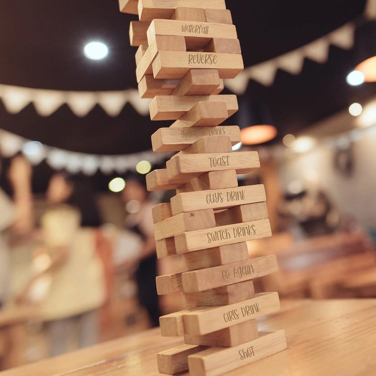 a wooden block tower sitting on top of a table