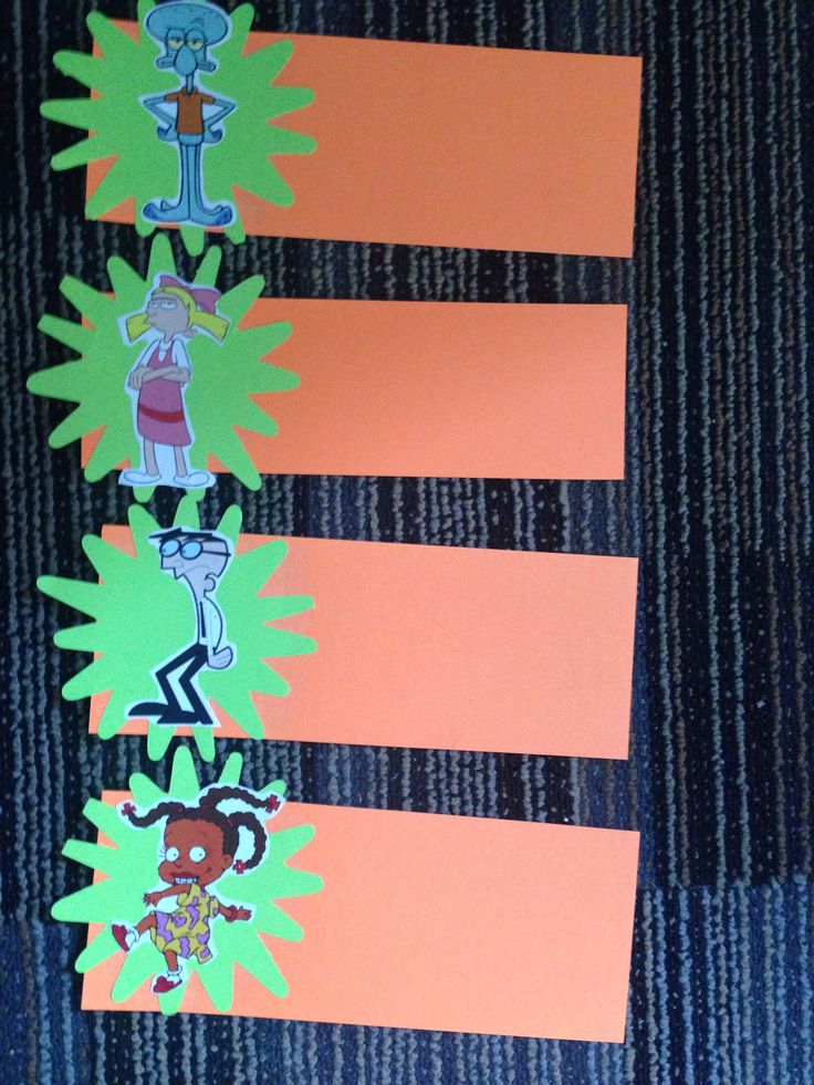 an orange and green striped paper strip with cartoon characters on it, next to some scissors