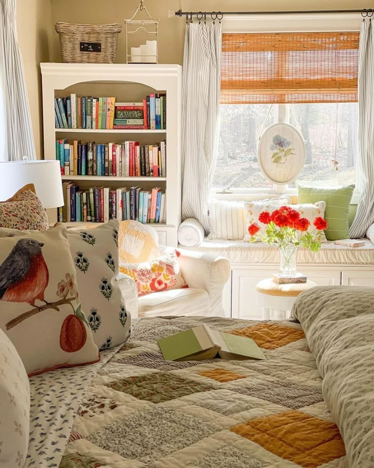 a bed room with a neatly made bed next to a book shelf filled with books