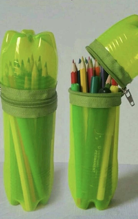 two green pencils and markers in a plastic container with zippered pouch on top