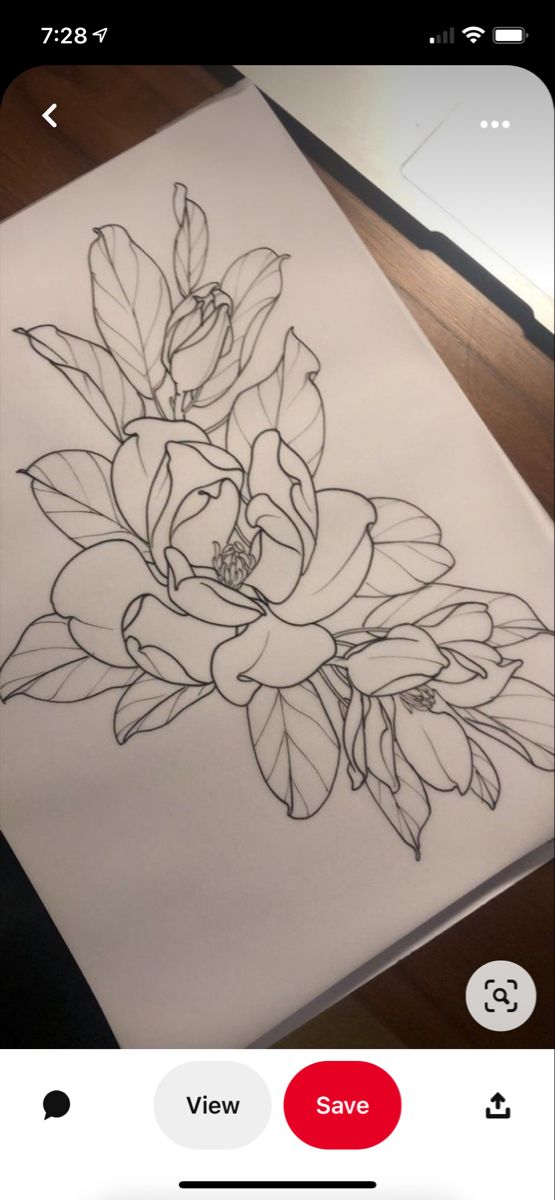 a drawing of some flowers on a piece of paper that is sitting on a table