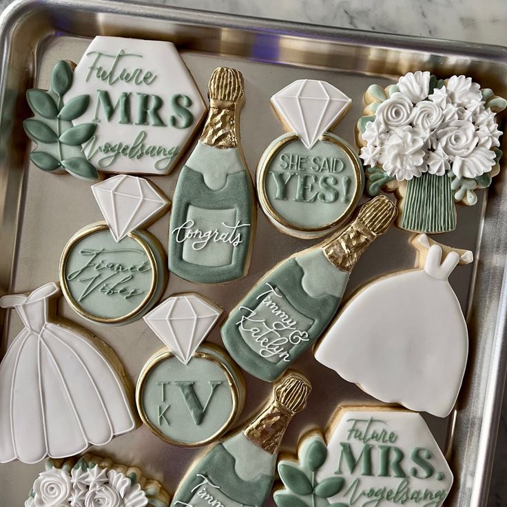 decorated cookies in the shape of bride and groom's names on a cookie sheet