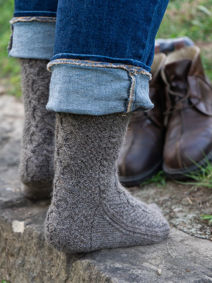 This top-down, richly-textured sock in two sizes S(L) is a gorgeous accessory for men and women alike. Worked in a warm, wooly yarn it is a hiking/rowing/snowshoeing essential; in sleek, smooth yarn it is a stylish accent to casual suits or slacks. With cabled details on all sides and cushy moss stitch panels, it is fun to work and a small project to be proud of—plus, a gift that says you think the most of a special someone. Shown here is size S in Border Leicester Fingering, color Rainbow GrayS Casual Winter Hiking Socks, Casual Hiking Socks For Winter, Casual Knit Winter Socks, Winter Outdoor Brown Socks, Brown Winter Outdoor Socks, Casual Fitted Socks For Outdoor, Winter Outdoor Fitted Socks, Fitted Winter Outdoor Socks, Border Leicester