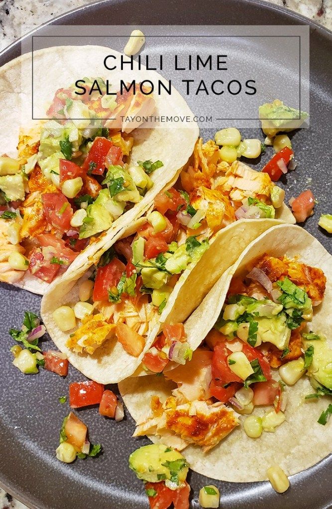 three tacos on a plate with salsa and avocado garnishes