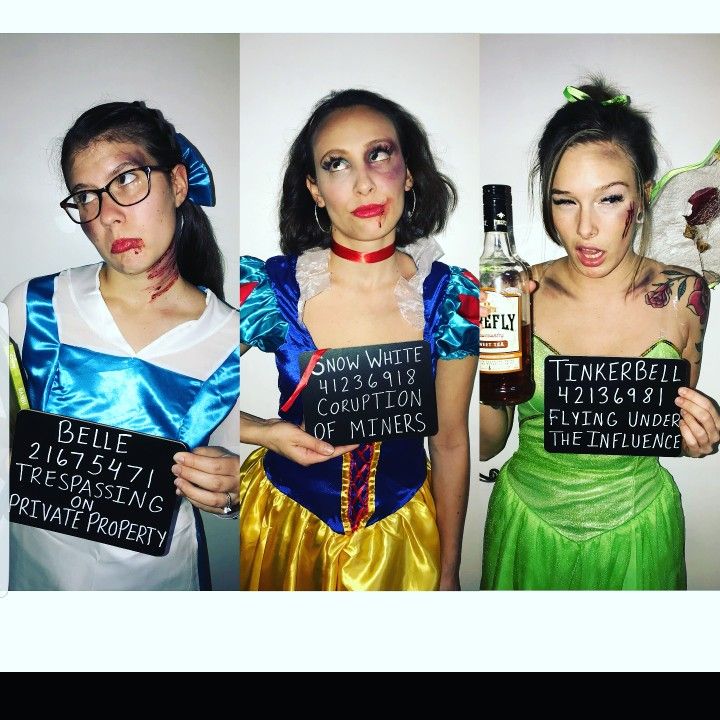 three women dressed in costumes holding up signs with words written on them that read,