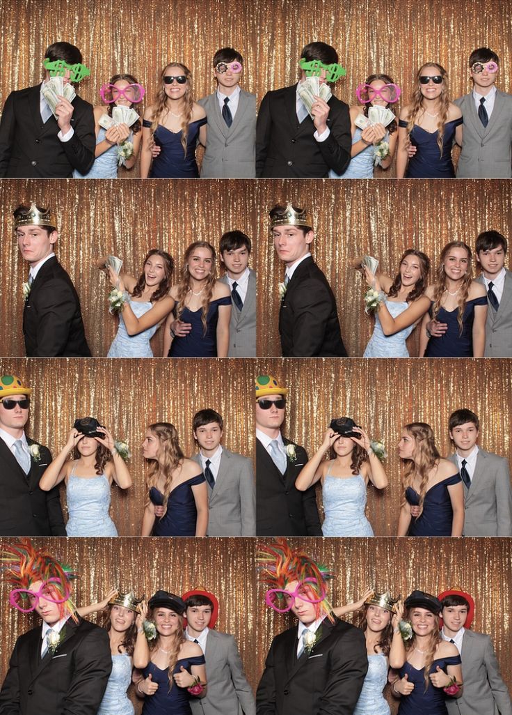 a group of people standing next to each other in front of a photo booth wall