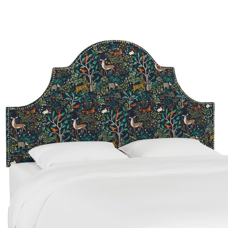 an upholstered headboard with deers and trees on the sides, against a white background