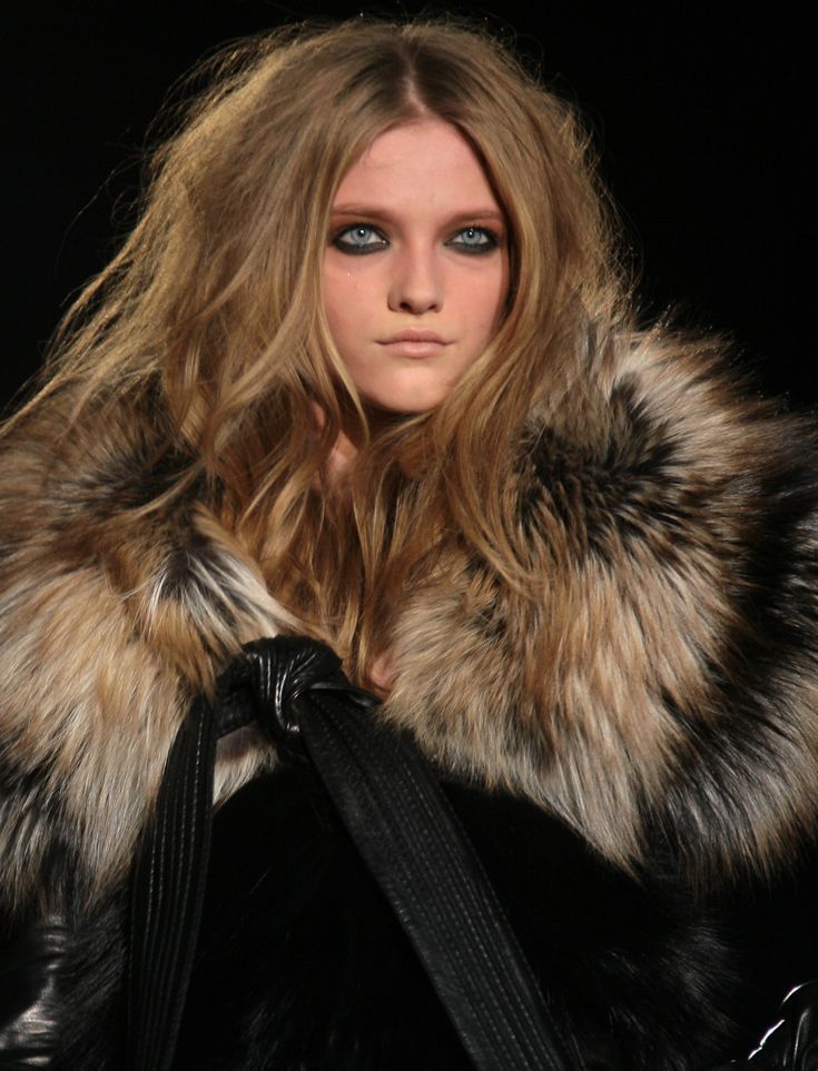 a model with blue eyes and fur coat