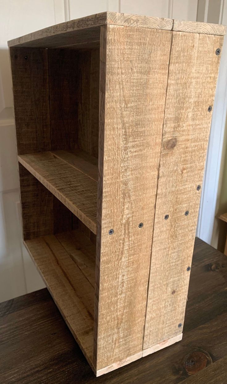 a wooden shelf sitting on top of a hard wood floor