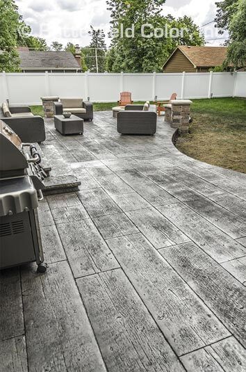 an outdoor patio with grills and chairs