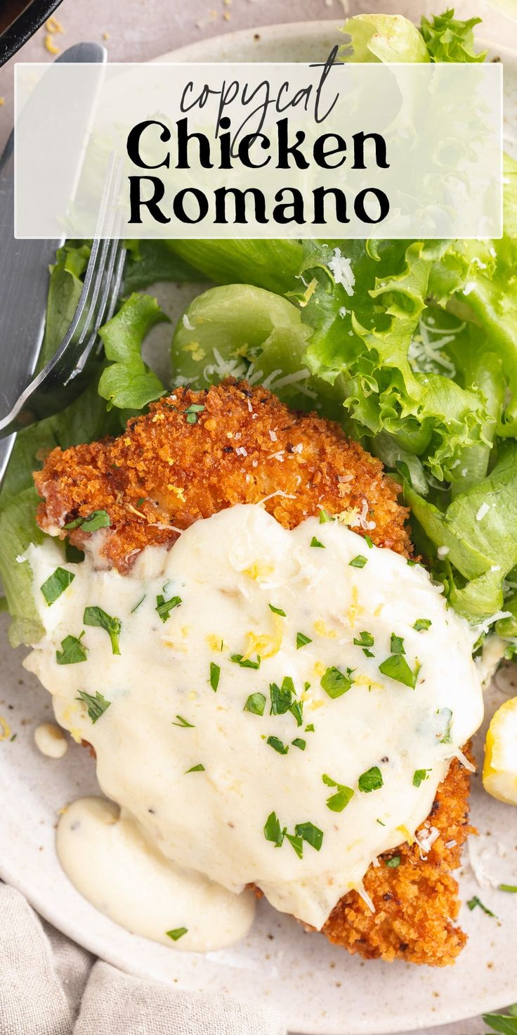 a white plate topped with chicken and lettuce covered in gravy next to a fork